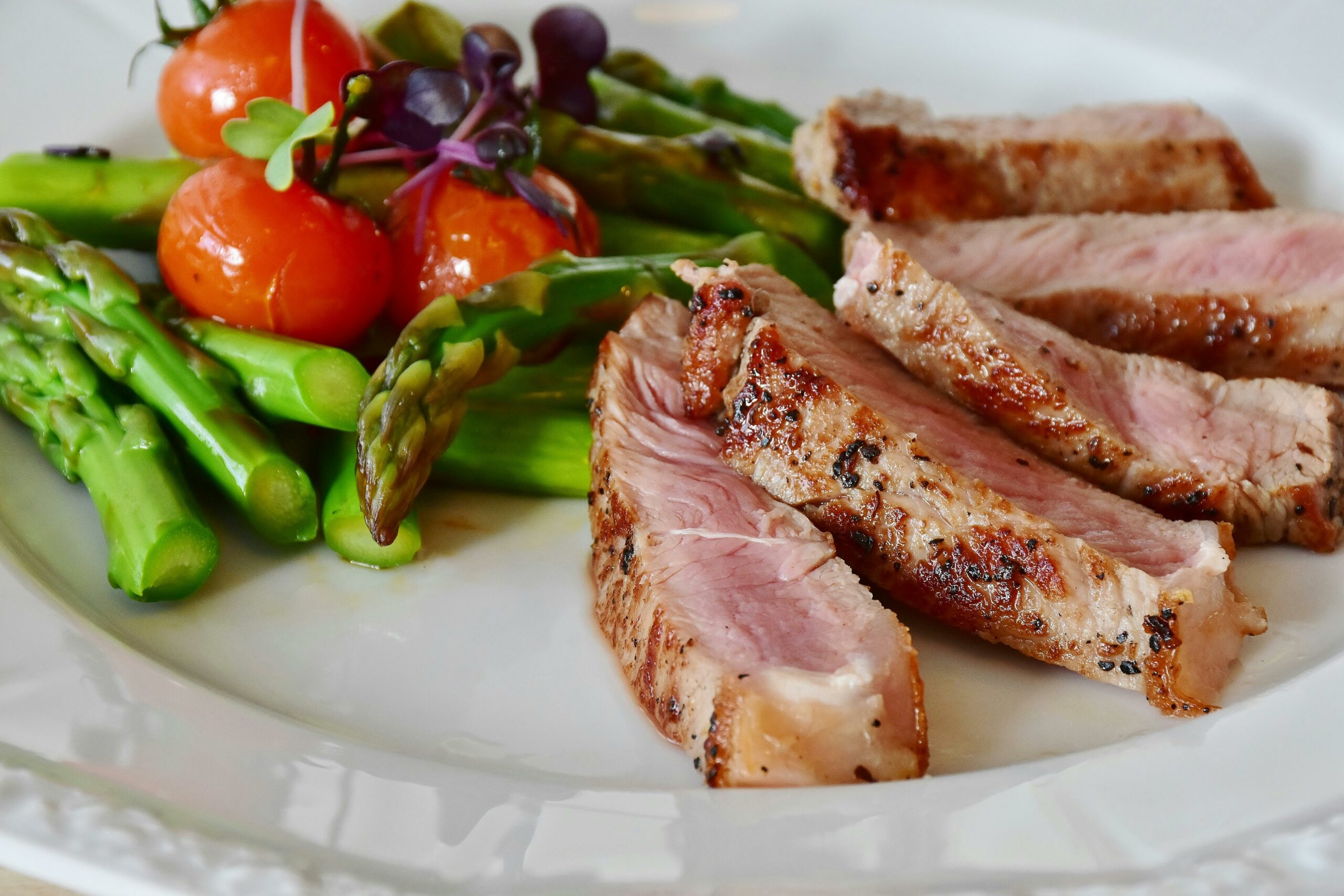 A plate featuring cooked meat and fresh salad.